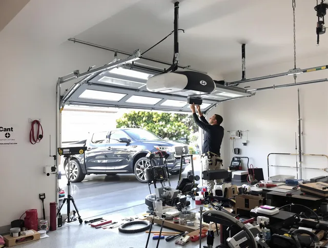 Cypress Garage Door Repair specialist installing smart garage door opener system in Cypress home
